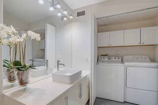 a view of a kitchen sink and refrigerator