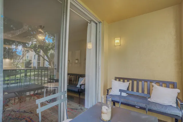 a view of a balcony and dining room