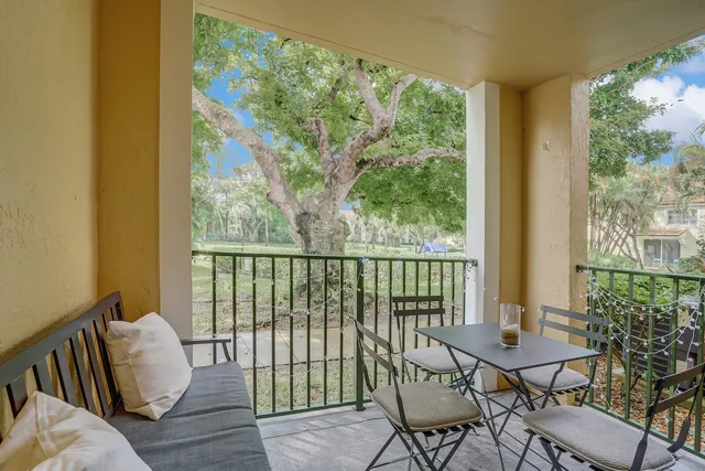 a balcony with chairs and a table