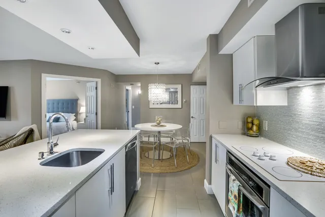 a kitchen that has a sink and a stove