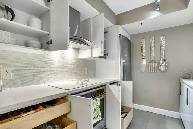 a kitchen with stainless steel appliances granite countertop a stove and a refrigerator