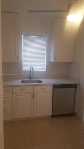 a kitchen with white cabinets