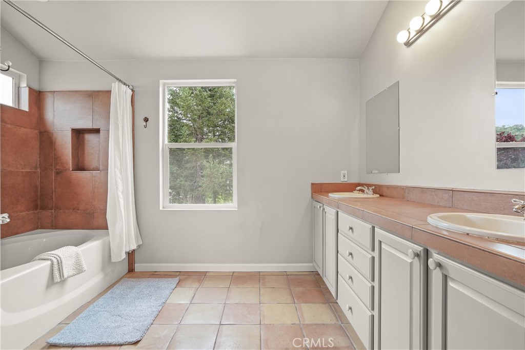 1691 Arbor Way Healdsburg, CA 95448 - Photo 11 of 25 a spacious bathroom with a tub sink and mirror