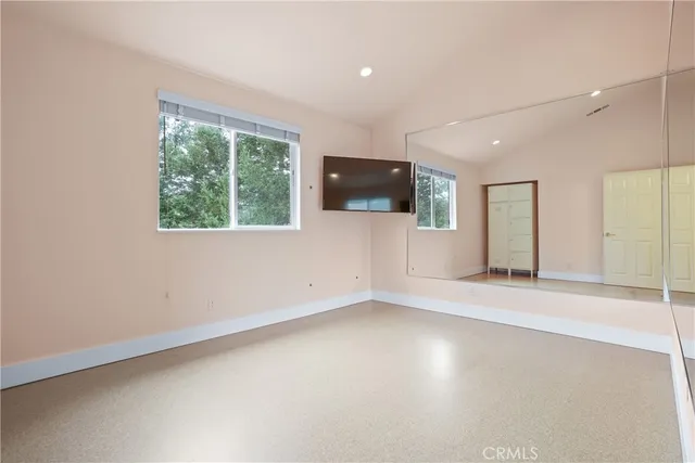 an empty room with windows and natural light