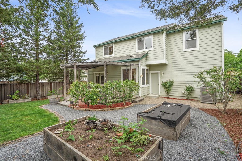 1691 Arbor Way Healdsburg, CA 95448 - Photo 22 of 25 a view of a backyard with table and chairs potted plants and wooden fence