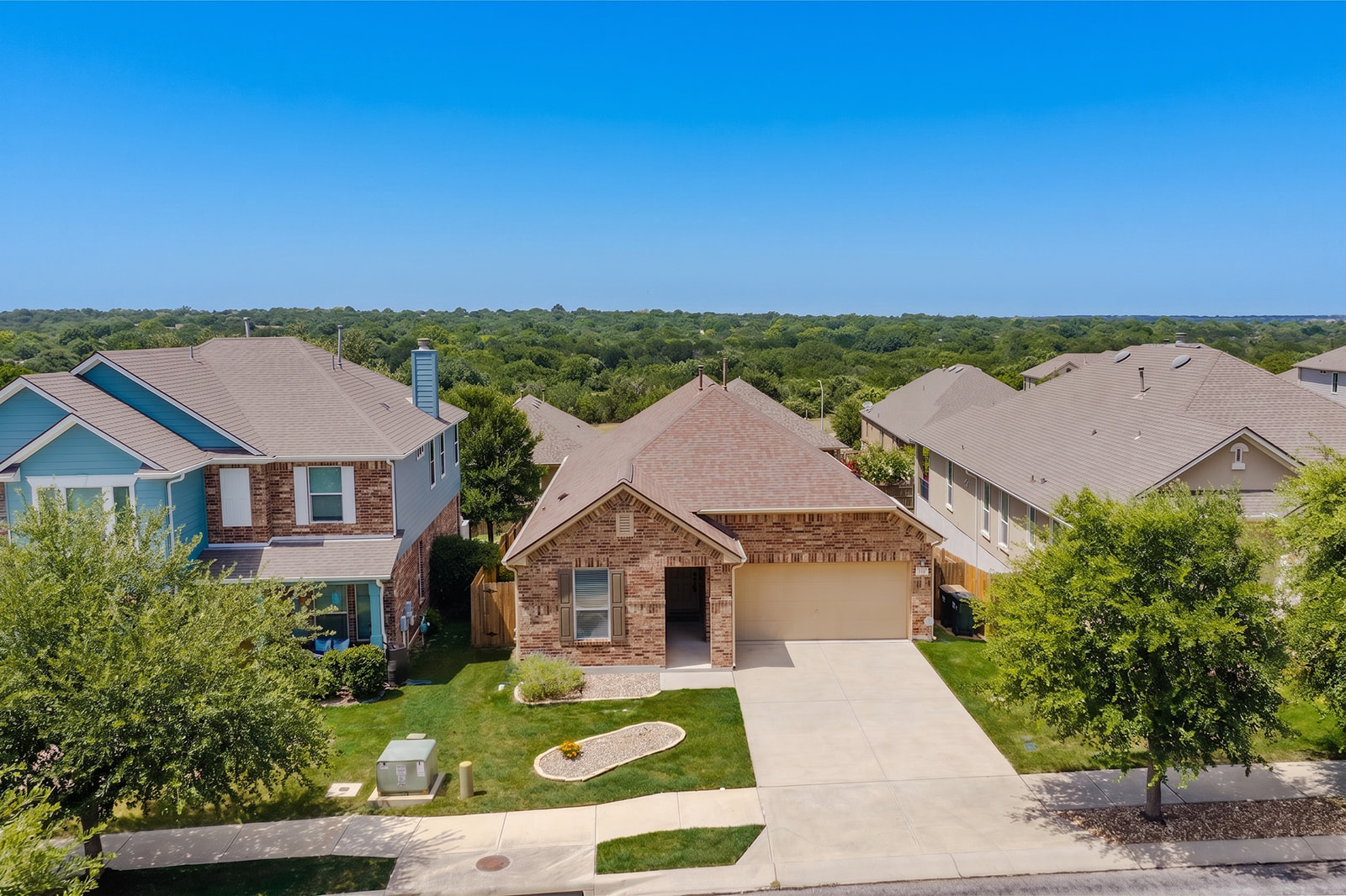 437 Sheepshank Drive Georgetown, TX 78633 - Photo 2 of 22 A welcoming suburban home presents a blend of brick and siding, featuring an attached 2-car garage and a neatly maintained front landscape.
