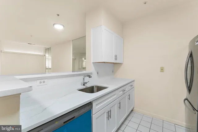 a kitchen with a sink cabinets and a refrigerator