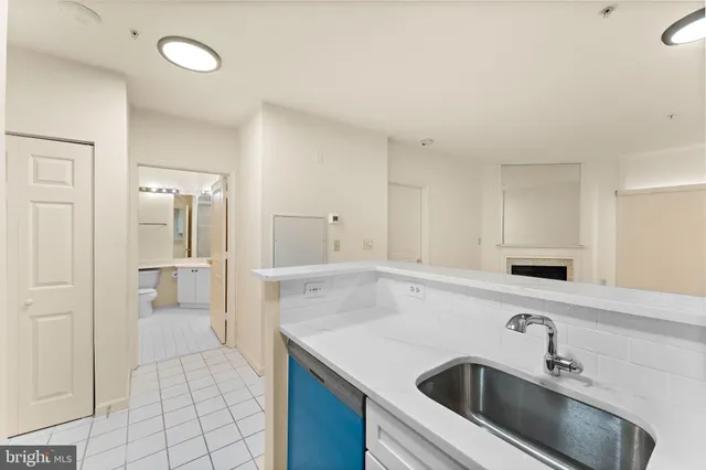 a view of a kitchen with a sink and refrigerator