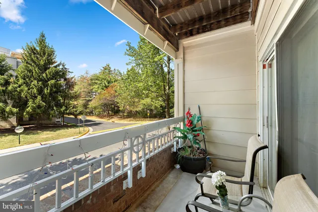a view of a chairs and table in the balcony