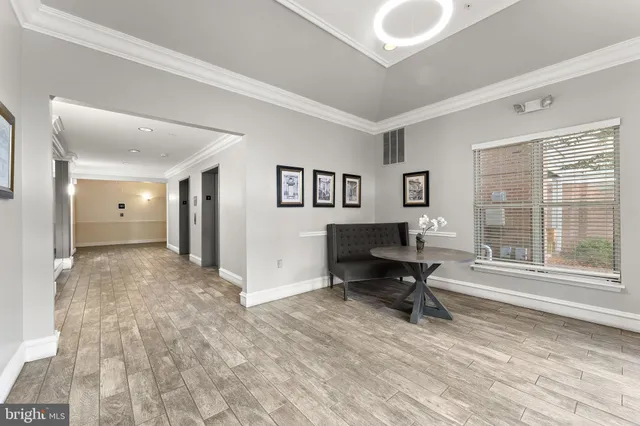 a view of a livingroom with workspace and a window