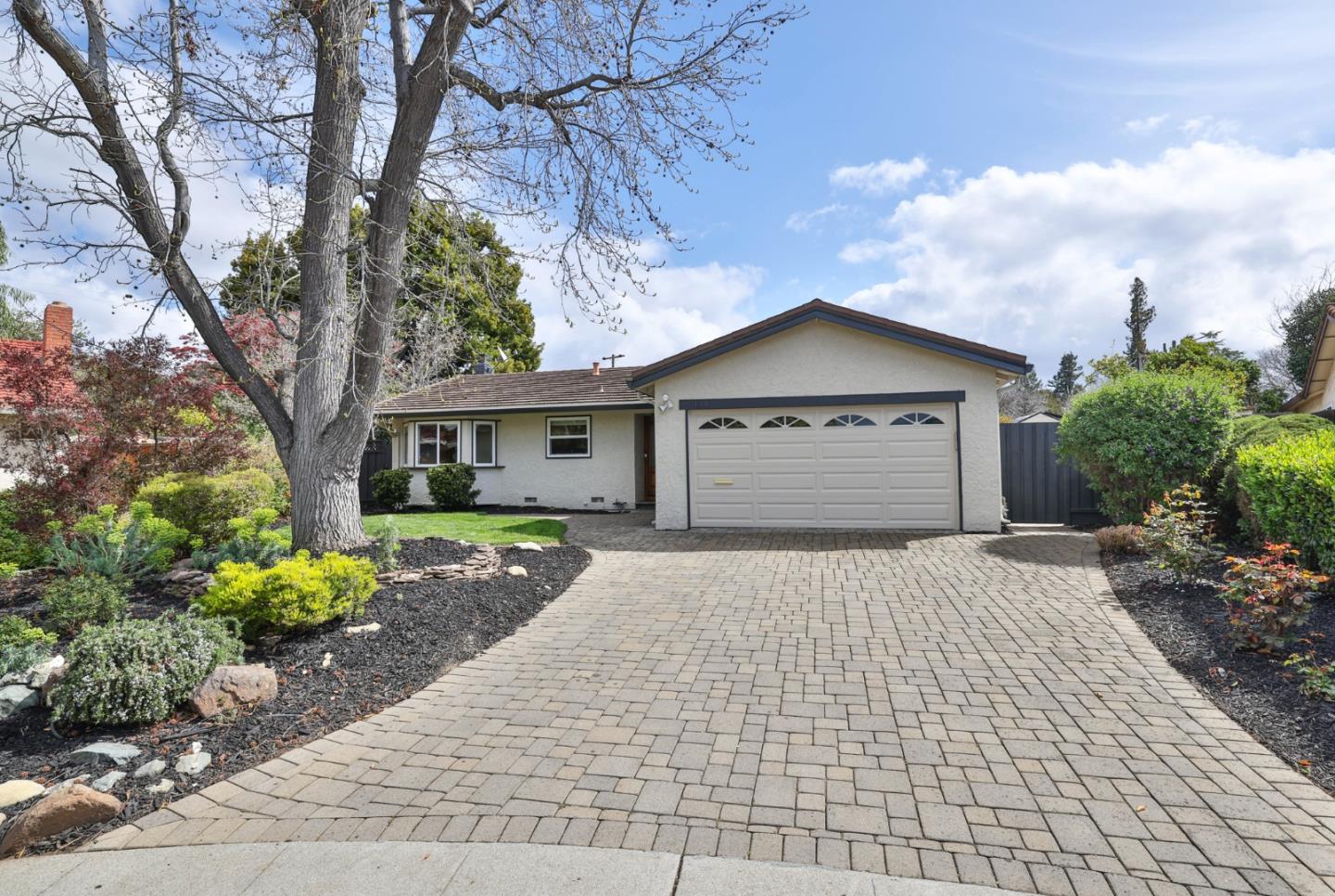 a front view of a house with a yard and a garage