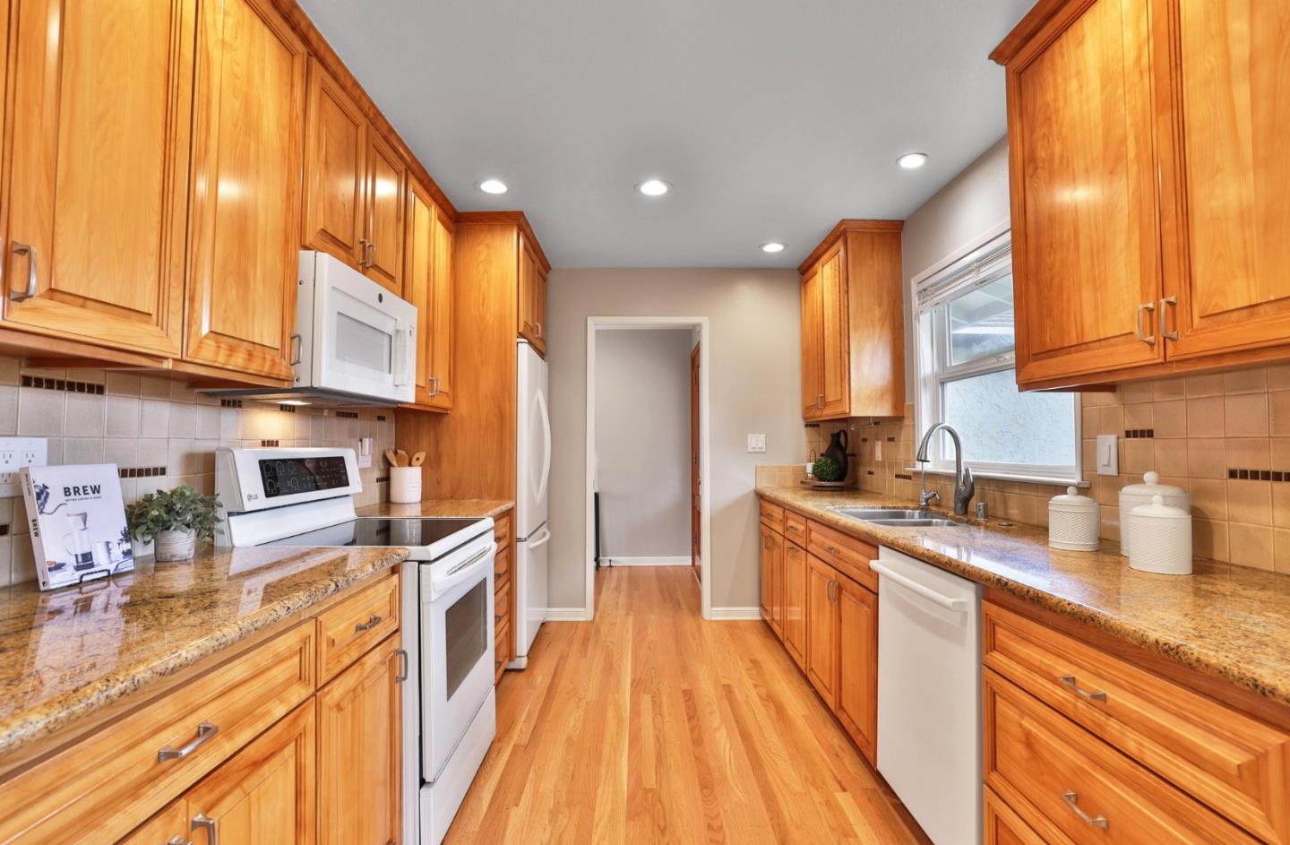 148 Jacinto Way Sunnyvale, CA 94086 - Photo 7 of 27 a kitchen with stainless steel appliances granite countertop a sink a stove and a wooden cabinets