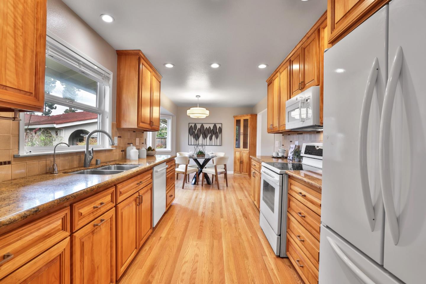 148 Jacinto Way Sunnyvale, CA 94086 - Photo 8 of 27 a view of a kitchen with kitchen island a counter top space a sink a refrigerator and a view of living room