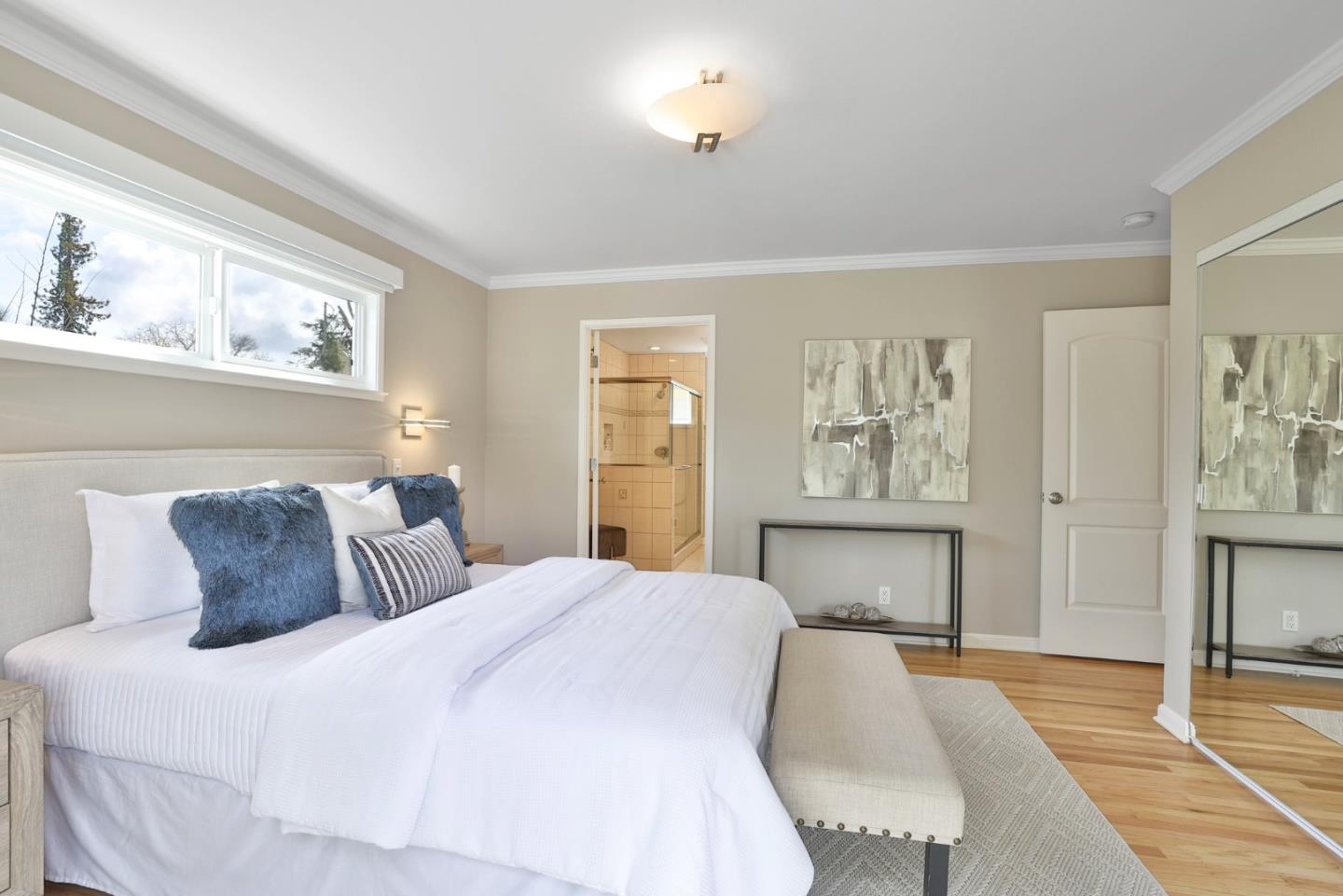 148 Jacinto Way Sunnyvale, CA 94086 - Photo 10 of 27 a bedroom with a large bed a chandelier and closet