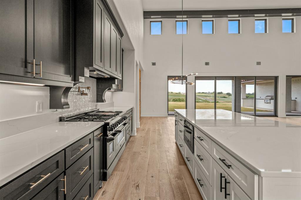227 High View Trail Aledo, TX 76008 - Photo 16 of 40 a kitchen with stainless steel appliances a sink stove and cabinets