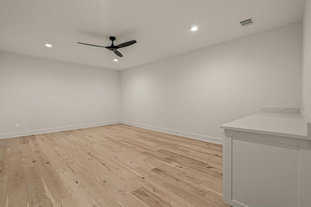 227 High View Trail Aledo, TX 76008 - Photo 36 of 40 an empty room with a ceiling fan and wooden floor