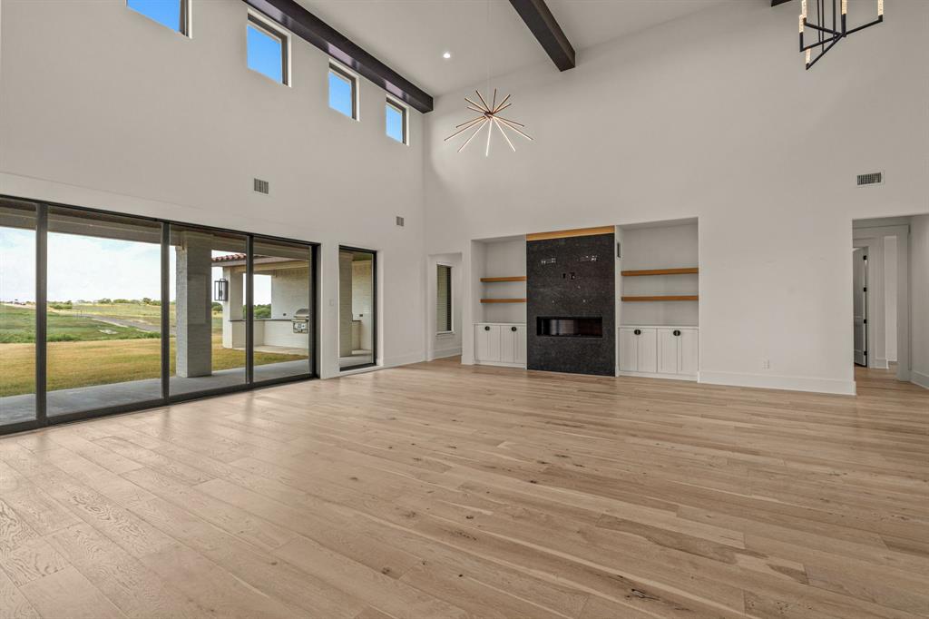 227 High View Trail Aledo, TX 76008 - Photo 8 of 40 a view of an empty room with a window and a kitchen