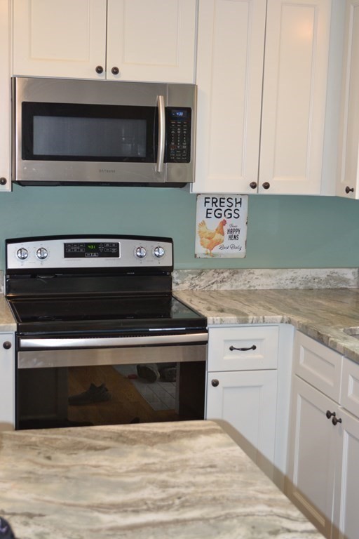 137 Center Depot Road Charlton, MA 01507 - Photo 6 of 31 a kitchen with granite countertop white cabinets stainless steel appliances and a sink