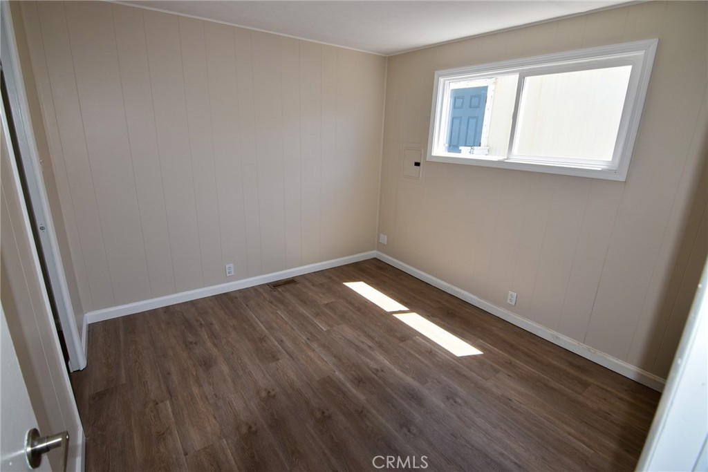 340 3rd Avenue, Unit 43 Pacifica, CA 94044 - Photo 12 of 19 an empty room with wooden floor and windows