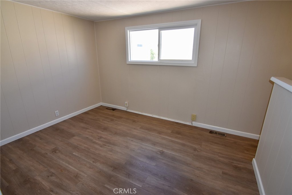 340 3rd Avenue, Unit 43 Pacifica, CA 94044 - Photo 14 of 19 an empty room with wooden floor and windows
