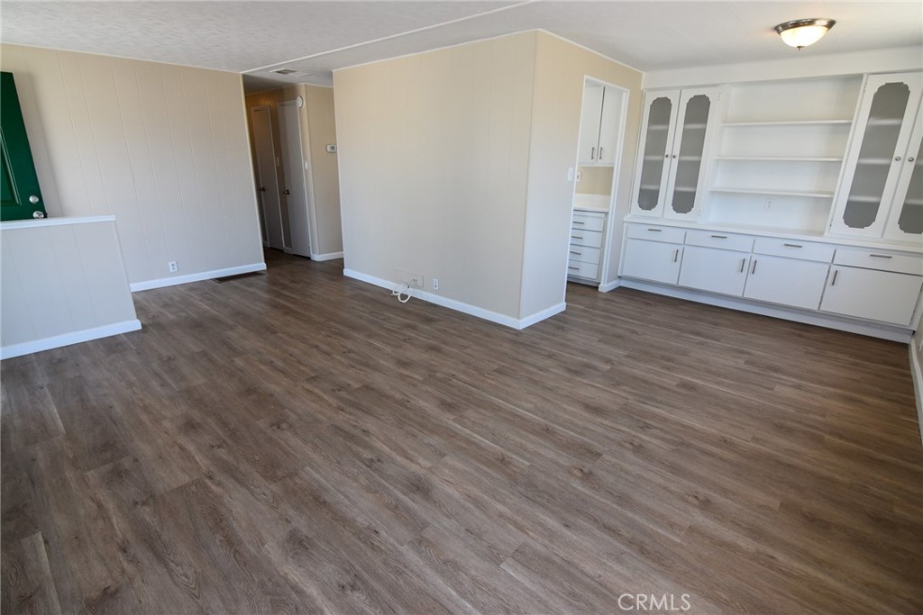 340 3rd Avenue, Unit 43 Pacifica, CA 94044 - Photo 7 of 19 an empty room with wooden floor and white walls