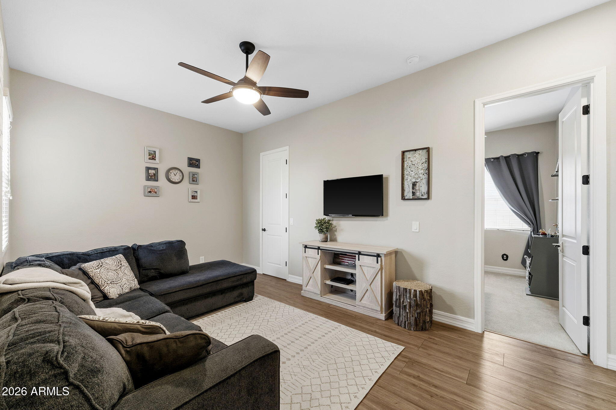 3921 East Chestnut Lane Gilbert, AZ 85298 - Photo 11 of 18 a living room with furniture and a flat screen tv