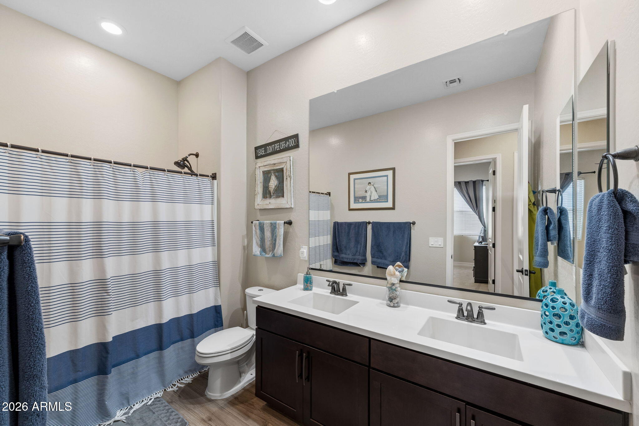3921 East Chestnut Lane Gilbert, AZ 85298 - Photo 12 of 18 a bathroom with a double vanity sink toilet and shower