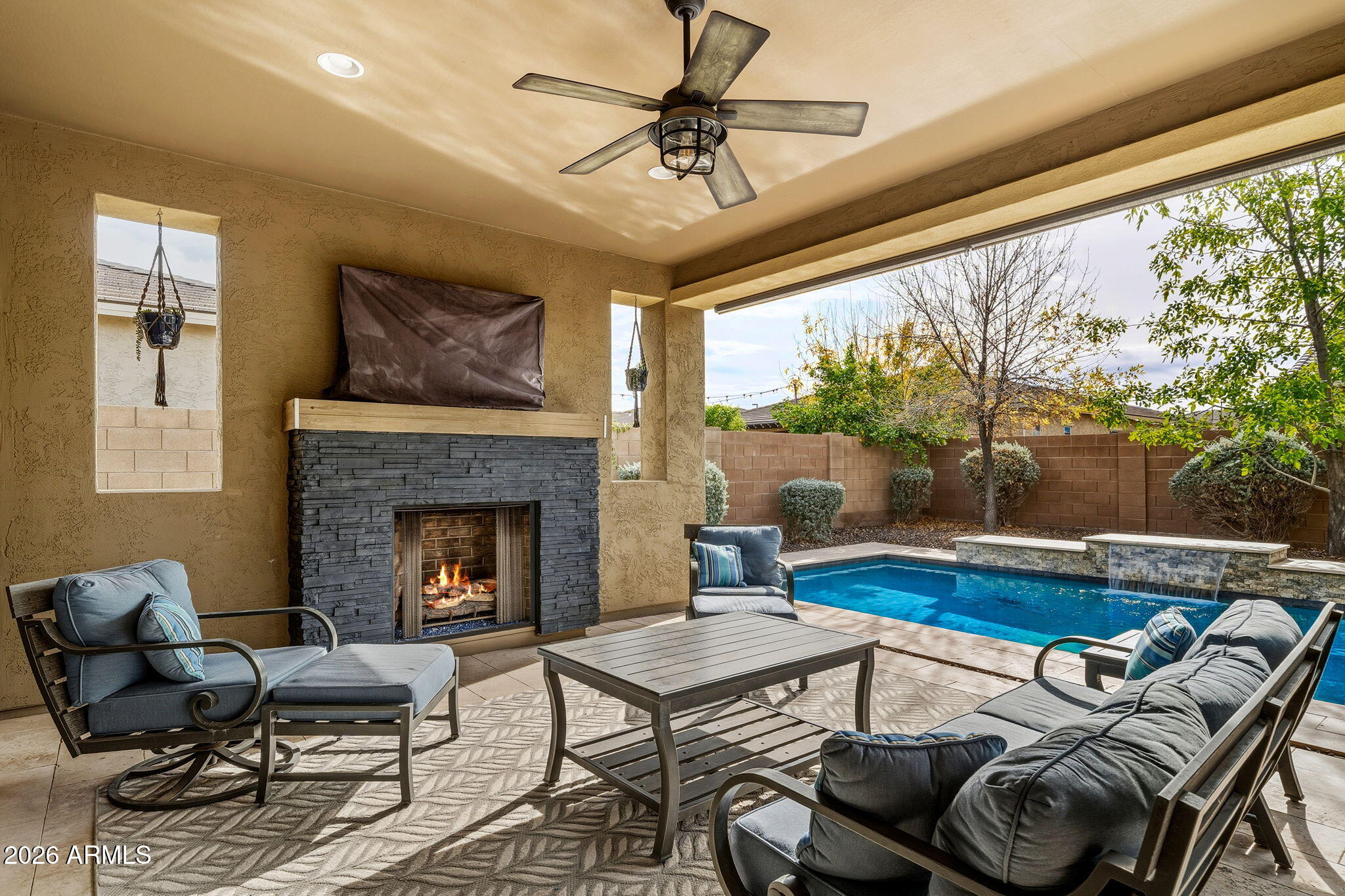 3921 East Chestnut Lane Gilbert, AZ 85298 - Photo 14 of 18 a living room with furniture and a fireplace