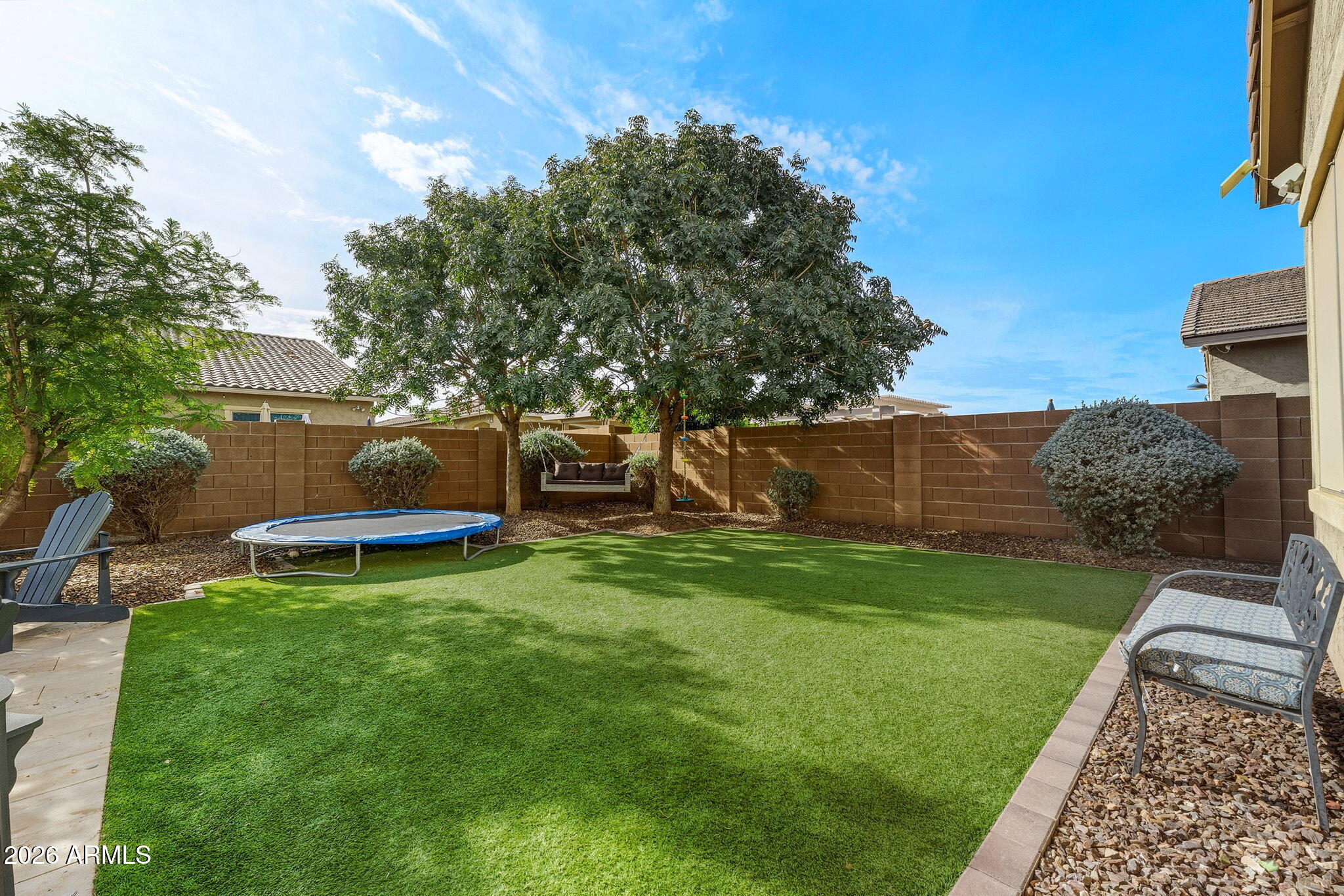 3921 East Chestnut Lane Gilbert, AZ 85298 - Photo 17 of 18 a view of a backyard with couches plants and large tree