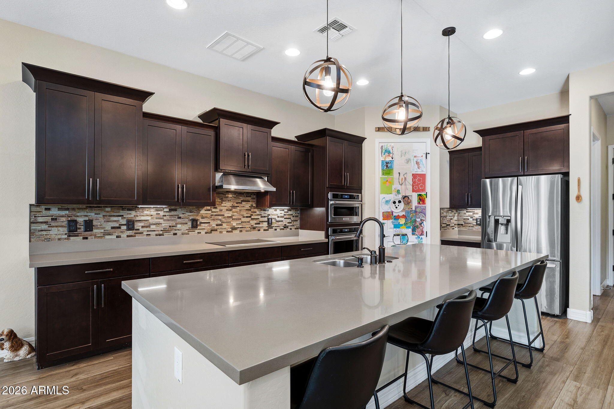 3921 East Chestnut Lane Gilbert, AZ 85298 - Photo 4 of 18 a large kitchen with a table and chairs