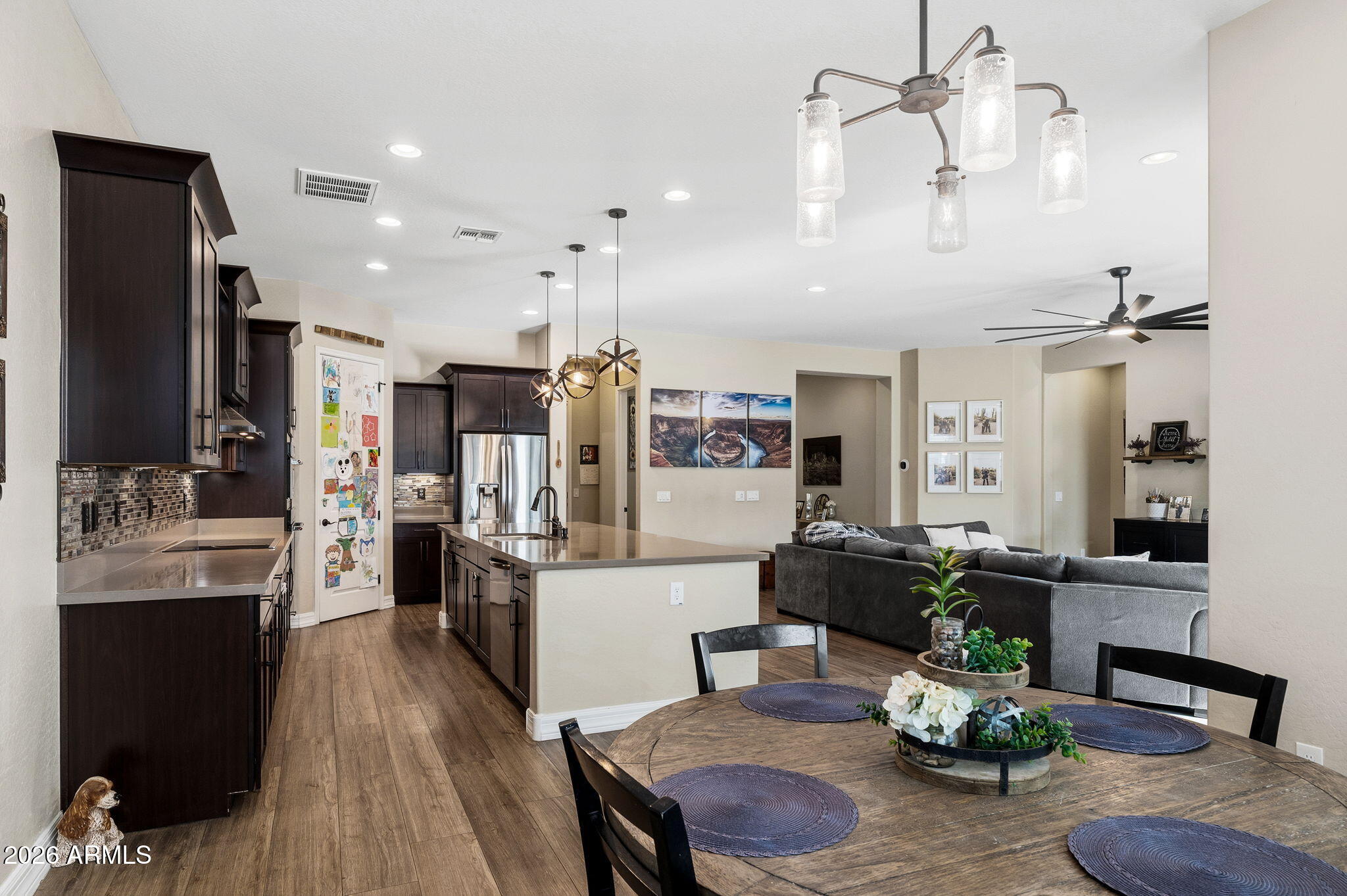 3921 East Chestnut Lane Gilbert, AZ 85298 - Photo 5 of 18 a living room with stainless steel appliances kitchen island granite countertop furniture wooden floor and a view of kitchen