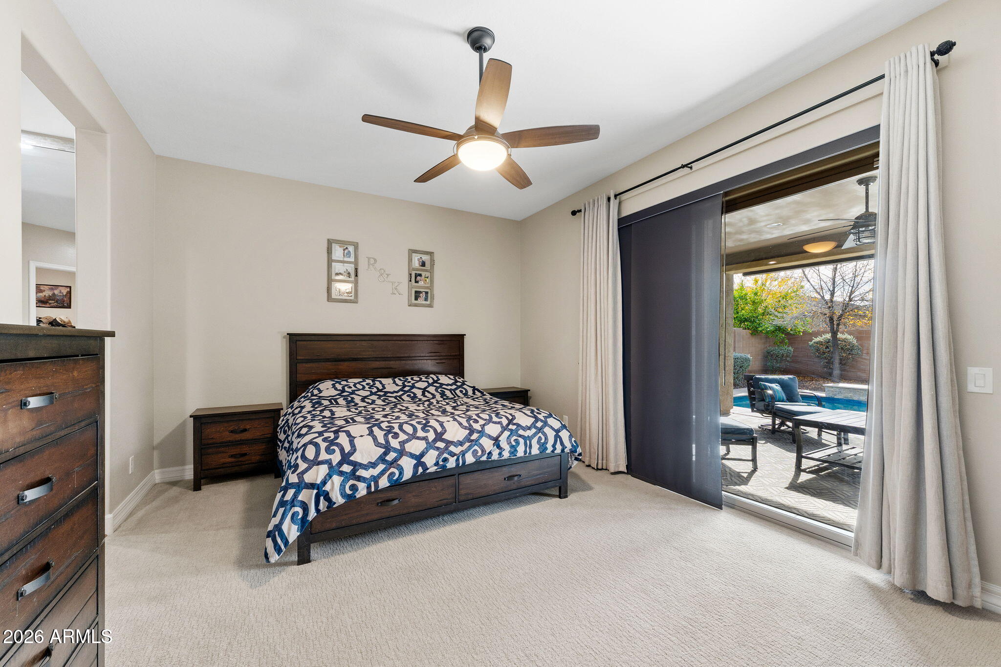 3921 East Chestnut Lane Gilbert, AZ 85298 - Photo 8 of 18 a bedroom with a bed and a dresser next to a window