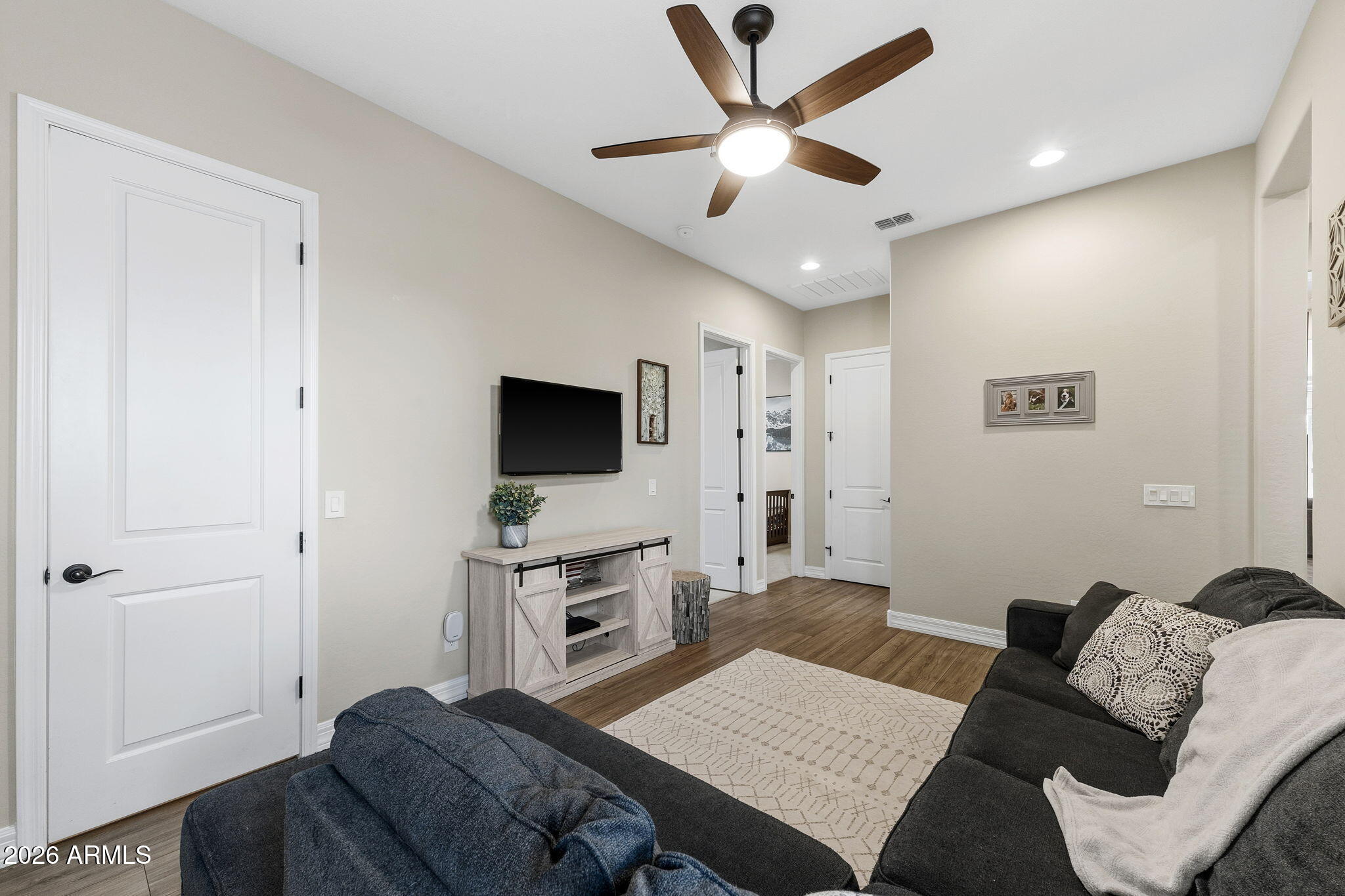 3921 East Chestnut Lane Gilbert, AZ 85298 - Photo 10 of 18 a living room with furniture and a flat screen tv