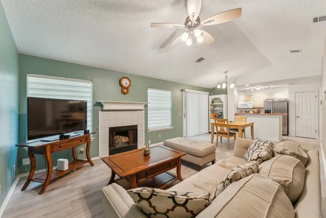 a living room with furniture a flat screen tv and a fireplace