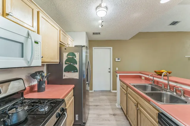 a kitchen that has a sink and a stove