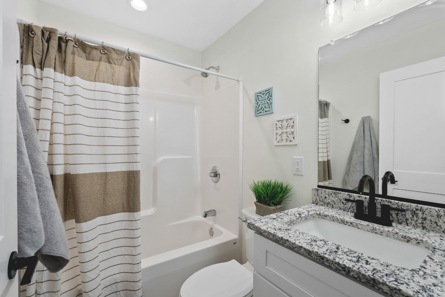 93 Halsey Road Lynchburg, VA 24501 - Photo 16 of 24 a bathroom with a granite countertop tub sink and mirror