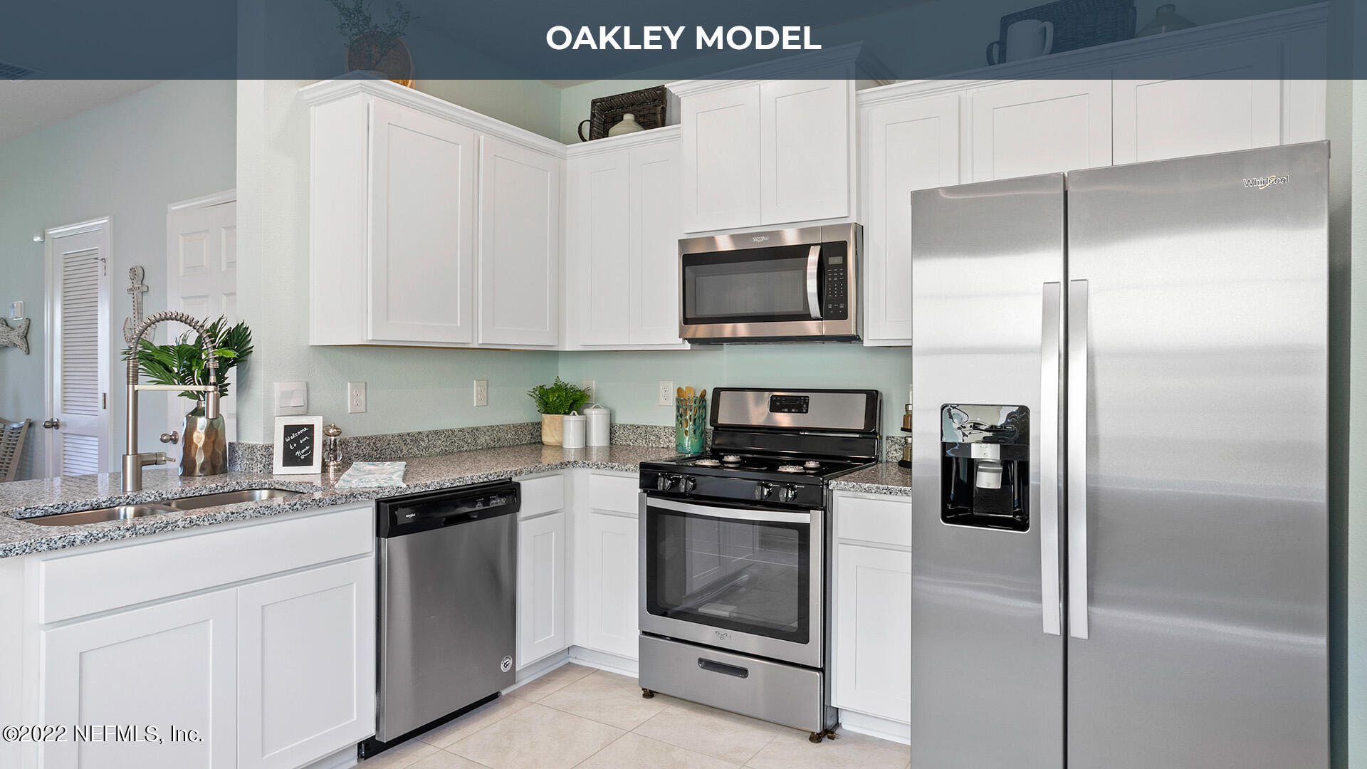 79 Ember Street St. Augustine, FL 32092 - Photo 5 of 31 a kitchen with white cabinets stainless steel appliances and a counter top space