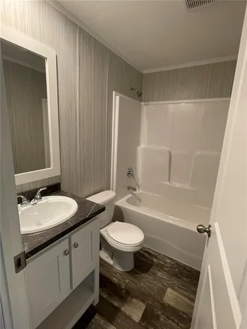 a bathroom with a sink a toilet a mirror and shower