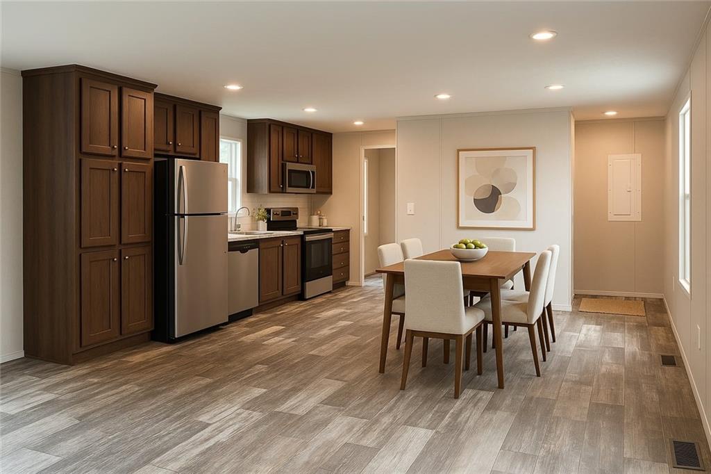 5118 A Holly Road Mount Pleasant, PA 15666 - Photo 2 of 17 a view of a dining room with furniture a refrigerator and wooden floor