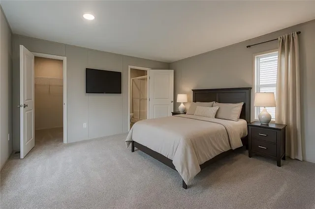 a bedroom with a bed and a tv