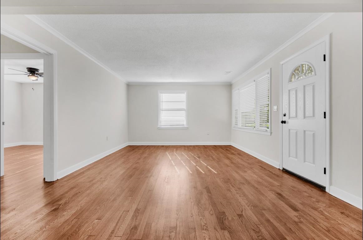 749 Lydgate Road Memphis, TN 38116 - Photo 15 of 30 an empty room with wooden floor and windows