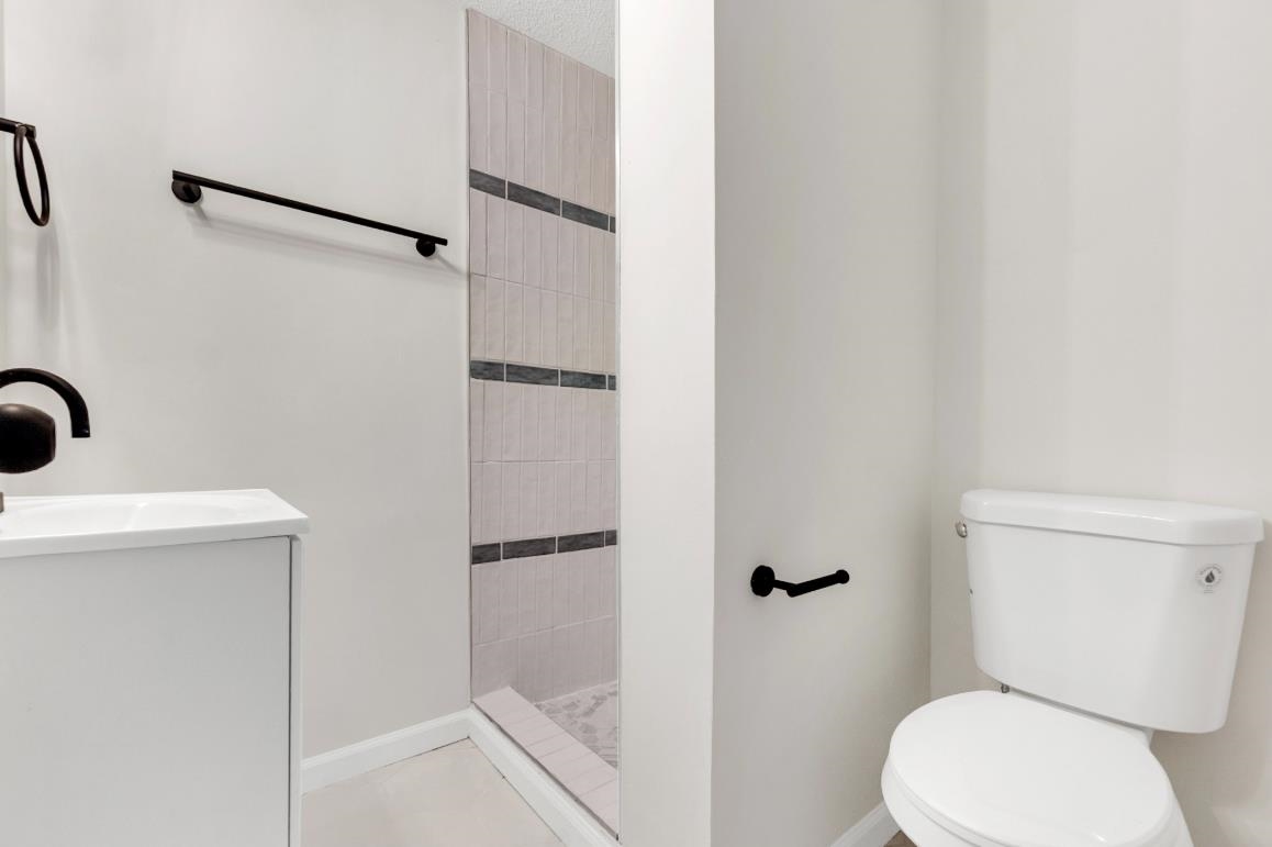 749 Lydgate Road Memphis, TN 38116 - Photo 25 of 30 a white toilet sitting next to a bathroom sink