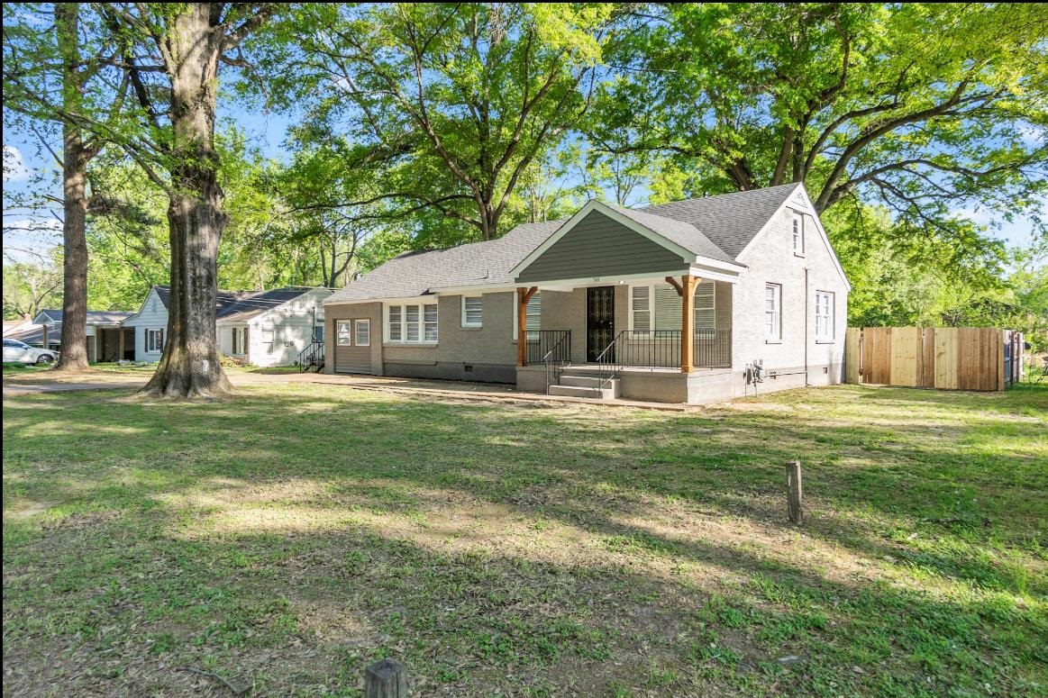 749 Lydgate Road Memphis, TN 38116 - Photo 3 of 30 a front view of a house with a garden and trees