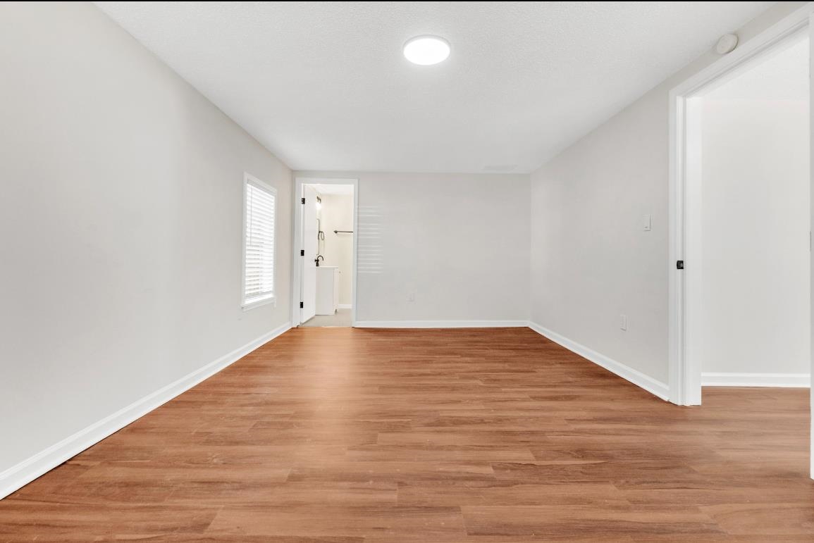 749 Lydgate Road Memphis, TN 38116 - Photo 7 of 30 a view of empty room with wooden floor and fan