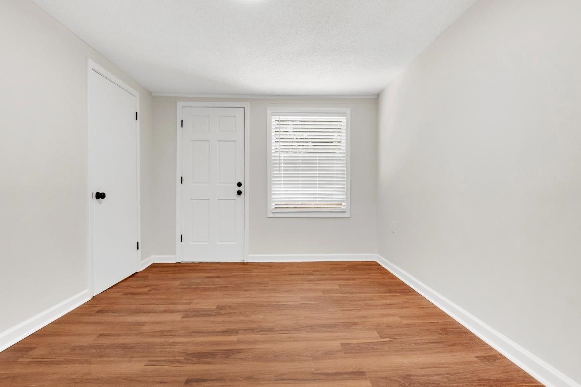 749 Lydgate Road Memphis, TN 38116 - Photo 8 of 30 a view of empty room with wooden floor and fan