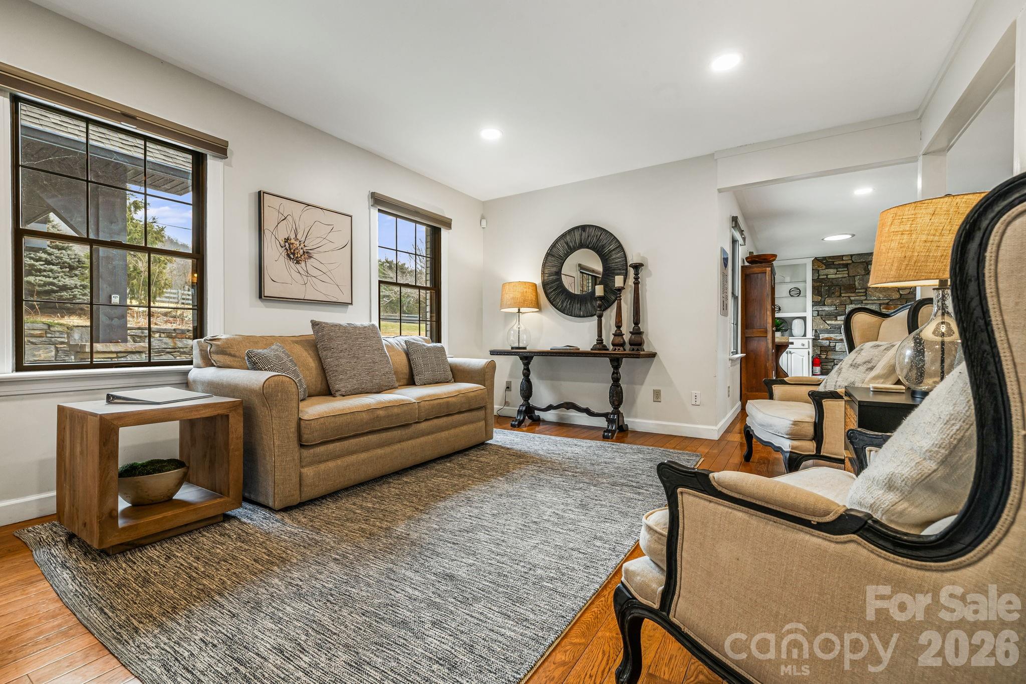 1236 Upper Brush Creek Road Fairview, NC 28730 - Photo 12 of 48 a living room with furniture a clock on wall and a window