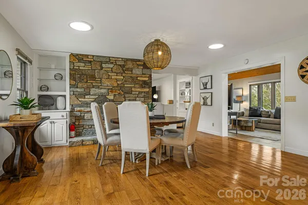 a dining room with furniture and wooden floor