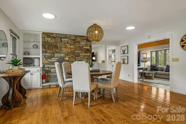 a dining room with furniture and wooden floor