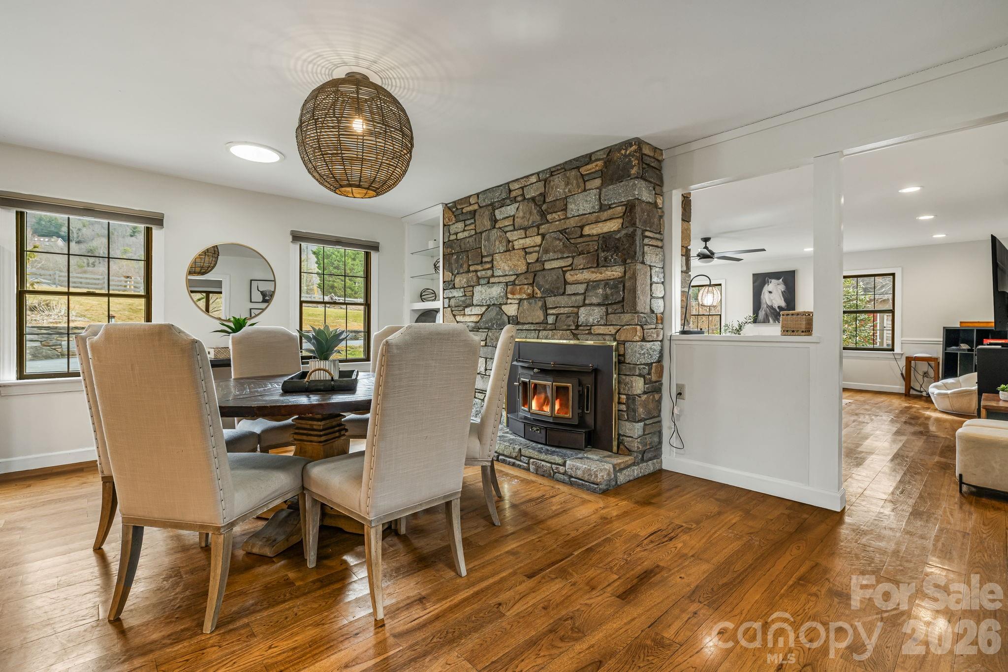 1236 Upper Brush Creek Road Fairview, NC 28730 - Photo 15 of 48 a view of a dining room with furniture a fireplace and wooden floor