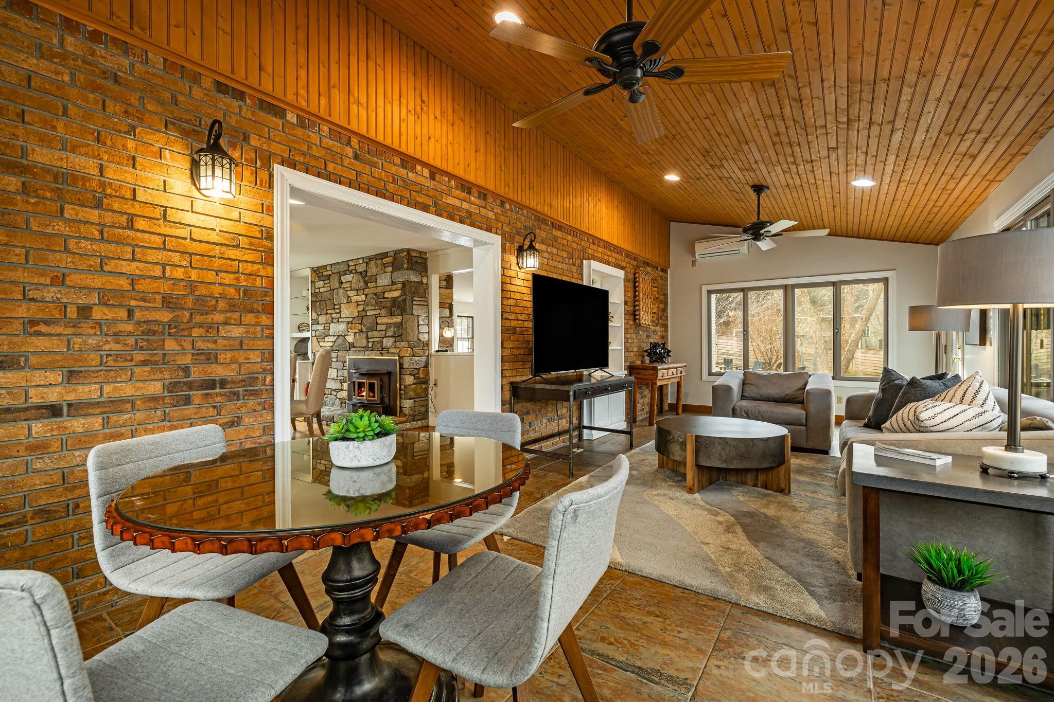 1236 Upper Brush Creek Road Fairview, NC 28730 - Photo 17 of 48 a dining room with furniture and a flat screen tv